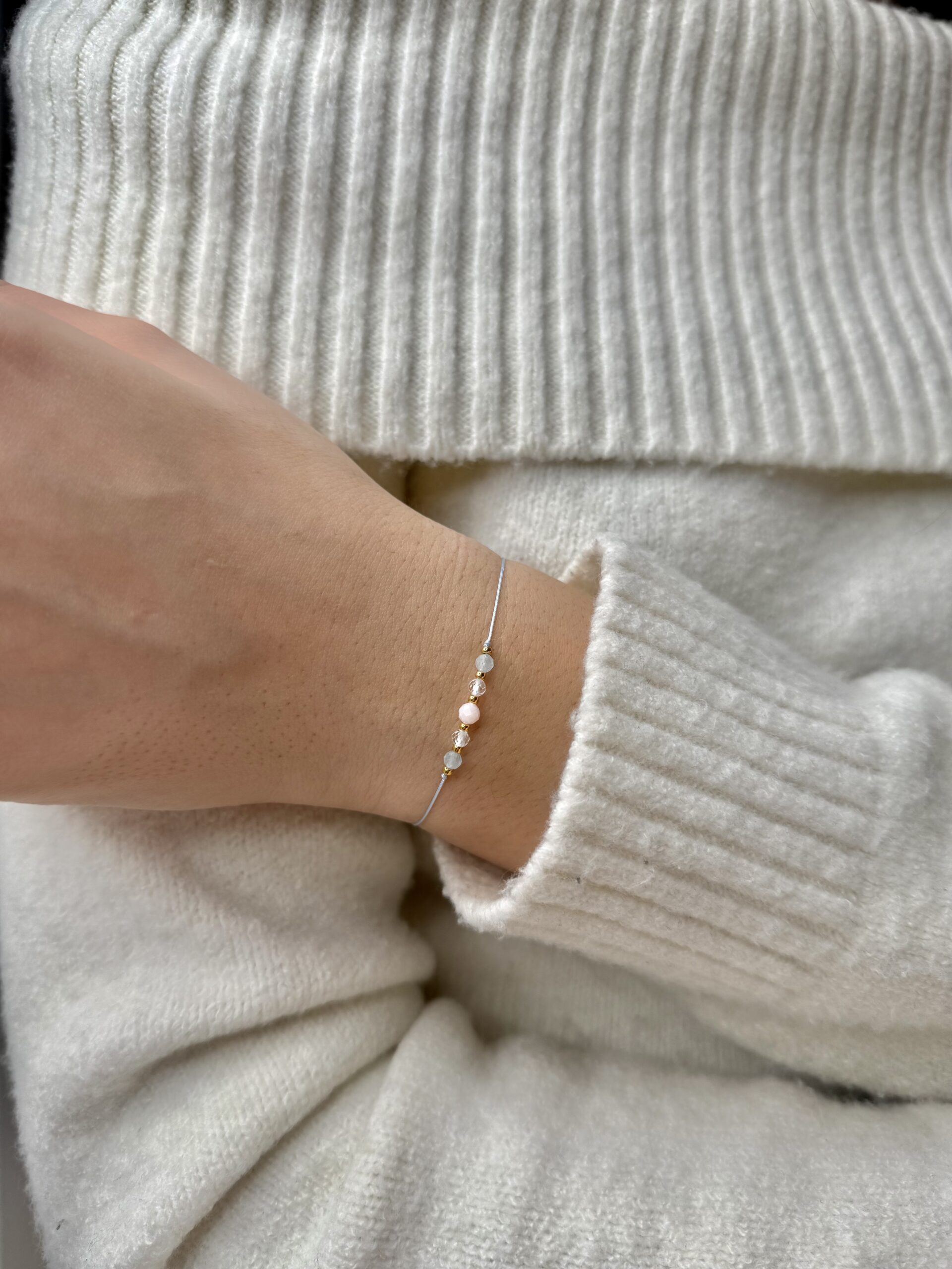 ręcznie robiona bransoletka wodnik z naturalnymi kamieniami akwamaryn, kryształ górski i opal, na nadgarstku